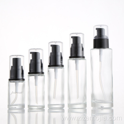 Empty round glass lotion bottle with pump